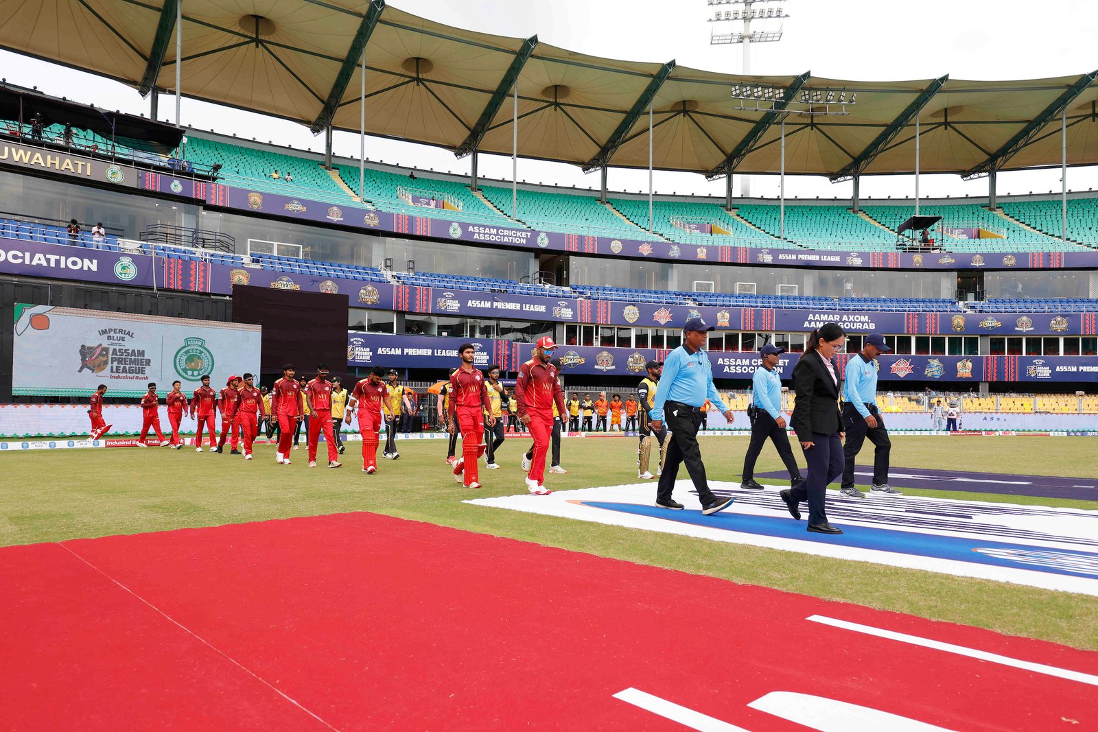 Players and match officials walking in during Match 29 of the APL T20 between Charaideo Sunrisers and Barak Legends at ACA Stadium, Barsapara, Guwahati, India, on August 15, 2026.

Photo by R.Param / CREIMAS